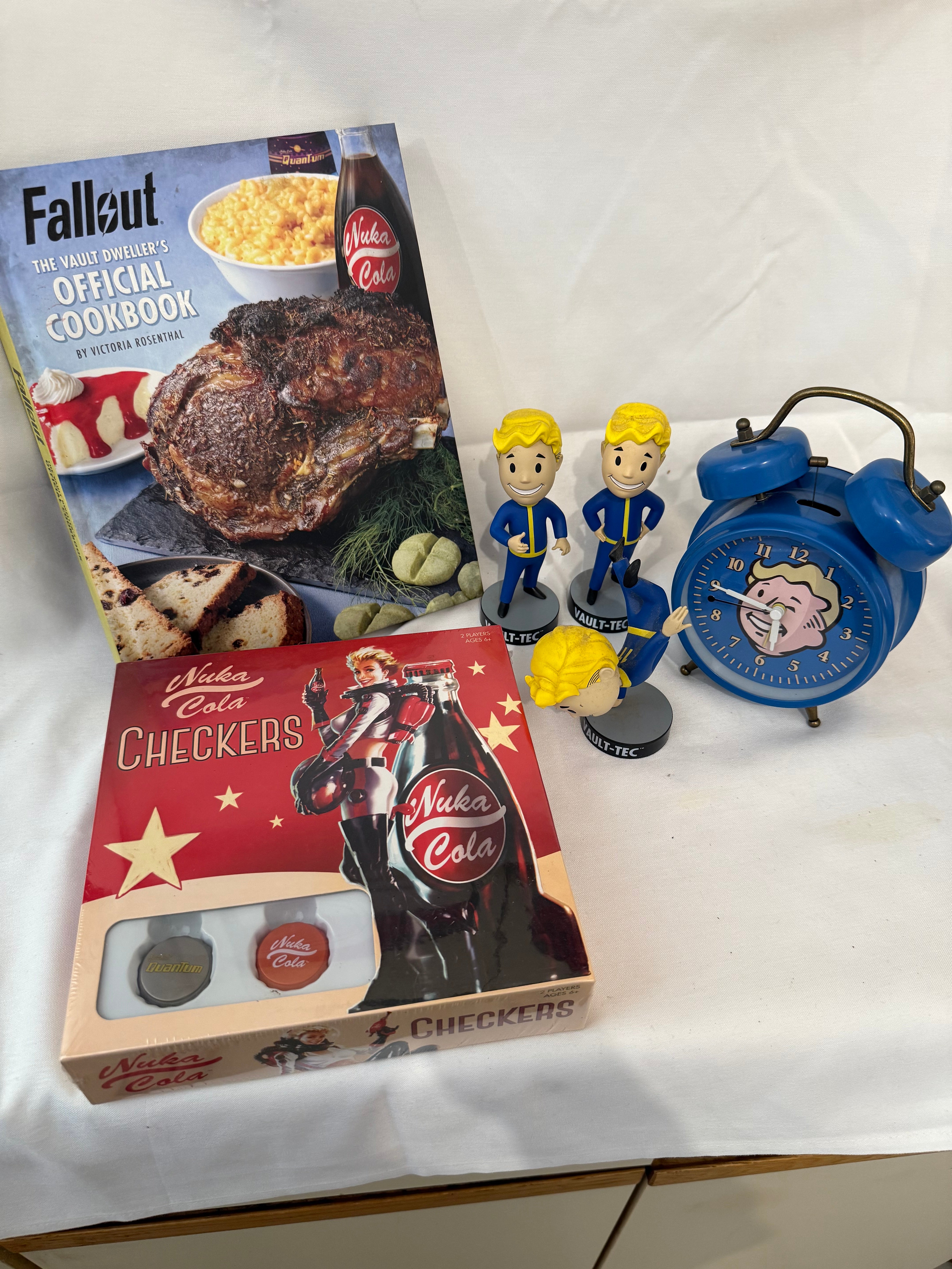Fallout Cookbook, Nuka Cola checkers, Fallout alarm clock and 3 Vault Tec bobble heads